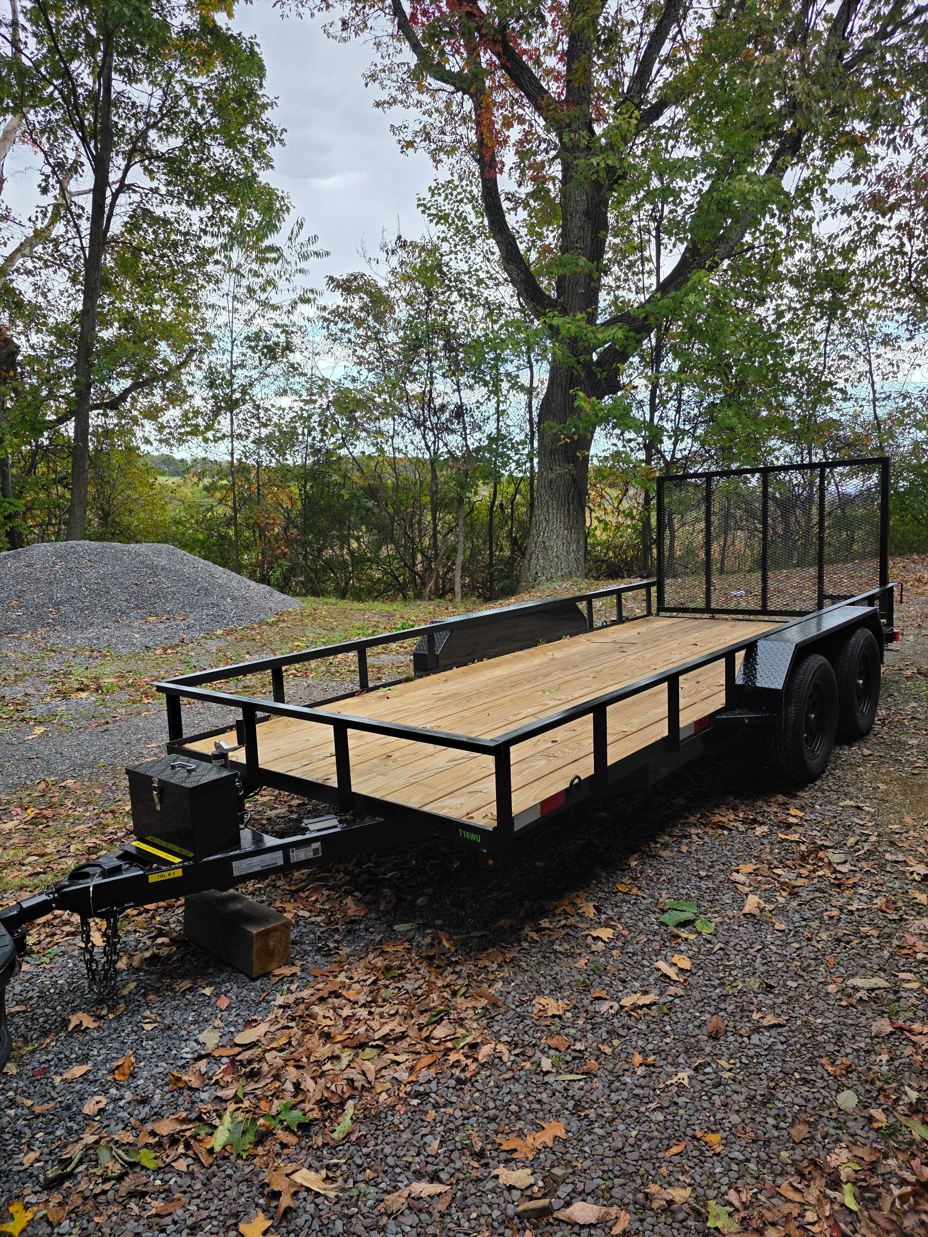 16 foot utility flatbed trailer with wood deck and mesh sides available for rent